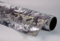 a roll of silver foil with black and white designs on it