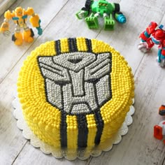 a birthday cake decorated with legos and an image of a transformer figure on it