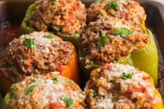 several stuffed peppers with meat and cheese on them