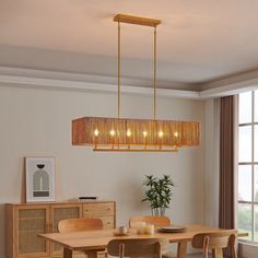 a dining room table and chairs with lights hanging from the ceiling