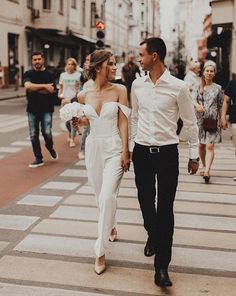 a man and woman are walking down the street