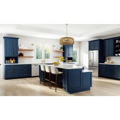 a large kitchen with blue cabinets and white counter tops, an island in the middle