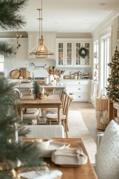 a christmas tree is in the middle of a kitchen with white cabinets and wooden tables