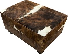 a brown and white cow hide ottoman