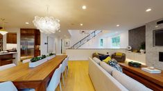 a living room filled with furniture and a flat screen tv mounted to the wall next to a fire place