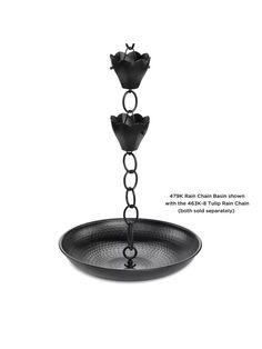 a black metal candle holder with chains hanging from it