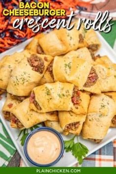 a plate full of cheesy crescent rolls with dipping sauce