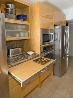 a kitchen with stainless steel appliances and wooden cabinets