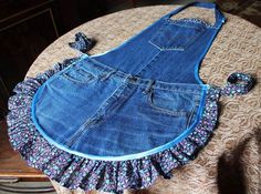 an apron made out of old jeans is sitting on a table