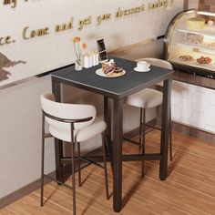 two white chairs sitting at a small table in front of an ice cream display case