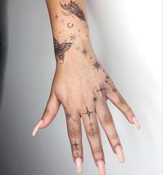 a woman's hand with tattoos on it