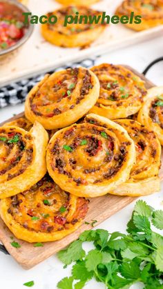 taco pinwheels on a cutting board with cilantro garnishes