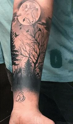 a man's arm with a full moon and tree tattoo on the left forearm