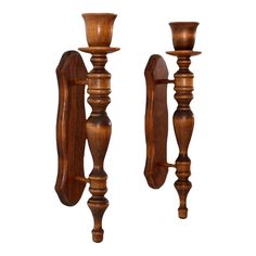 two wooden candlesticks are standing next to each other on a white background,