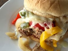 a white plate topped with a sandwich and pasta