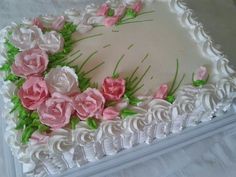 a cake with white frosting and pink flowers on it