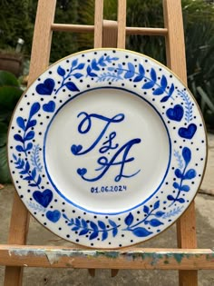 a blue and white plate sitting on top of a wooden chair