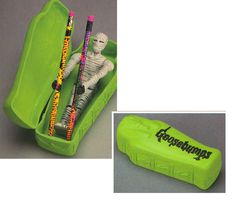 a green box with two pencils in it and a skeleton figure inside the container