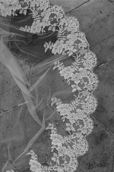 a wedding veil is laying on the ground