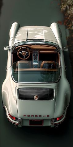 an old car is shown from above with its hood up