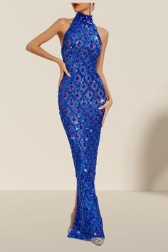 a woman wearing a blue dress with sequins on it