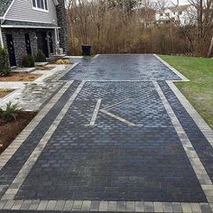 a paved driveway with an arrow painted on it