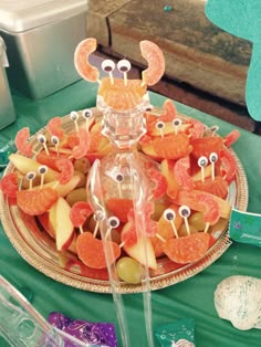 an assortment of fruit on a platter with eyeballs in the shape of crabs