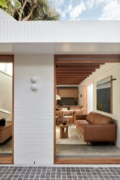 an open living room and dining area with sliding glass doors