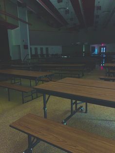 empty tables and benches in a large room