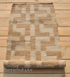 a brown and white rug sitting on top of a wooden floor