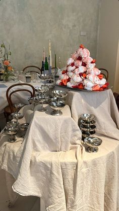 the table is covered with white linens and silverware