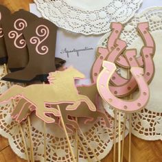 some pink and brown cupcake toppers on a table