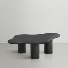 a black table sitting on top of a white floor