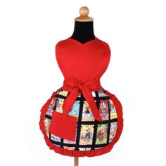 a red apron with pictures on it is sitting on a mannequin's head