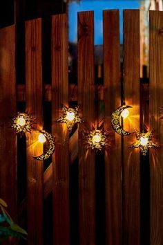 some lights that are on the side of a fence