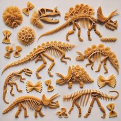 several different types of pasta shaped like dinosaurs and other animal shapes are arranged on a white surface