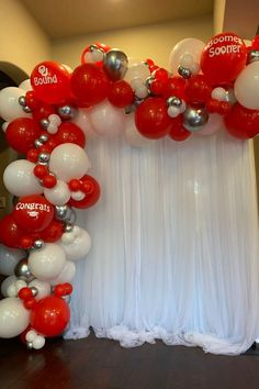 red and white balloons are hanging from the ceiling