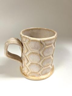 a white ceramic cup sitting on top of a table