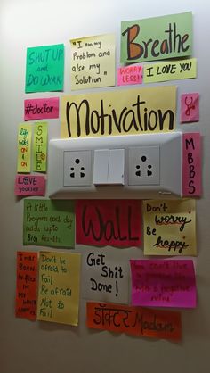 a bulletin board with words written on it and magnets attached to the back wall