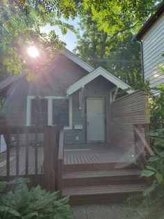 the sun shines brightly in front of a house with steps leading up to it