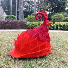 a red hat sitting on top of a lush green field