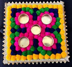 a colorfully decorated tray with four cups on it