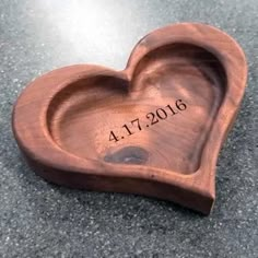 a heart shaped wooden box with the date on it