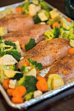 two pieces of meat and vegetables on a pan