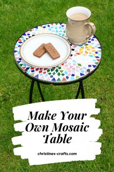 a table with two cookies on it and a cup of coffee next to it that says make your own mosaic table