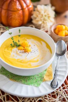 a white bowl filled with soup on top of a plate