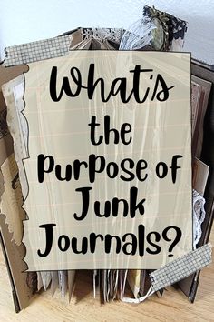 a pile of junk sitting on top of a wooden floor next to a sign that says, whats the purpose of junk journals?