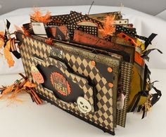 there is a halloween card holder made out of scraps and other items on the table