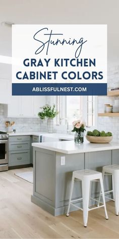 a white kitchen with gray cabinets and stools in front of the counter top is an island