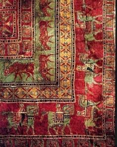 an old rug with animals on it